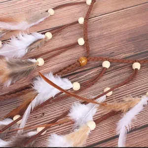 Detailed macro shot of bohemian ethnic feather headband with wooden beads and tassels