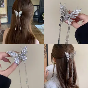 Detail of silver butterfly hair clip with elegant tassels for back hair styling.