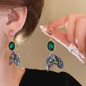 Elegant mermaid tail earrings with colorful rhinestones and green gems, silver needle post.