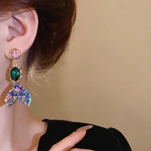 Fashionable silver needle earrings featuring colorful rhinestones and a mermaid tail drop