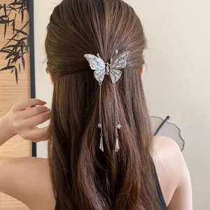 Close-up back view of an elegant silver butterfly hair claw clip featuring crystal tassels