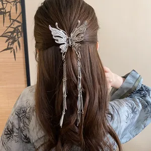 Detailed view of an elegant silver butterfly hair claw clip with long tassels on hair