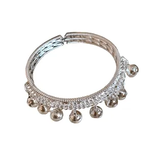Ethnic style silver bell charm bangle featuring a textured open cuff design for women