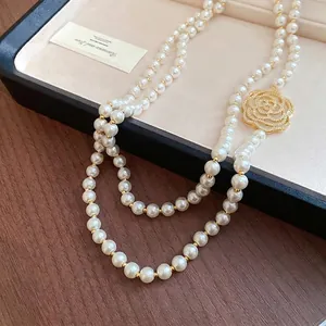 Elegant double-strand pearl necklace featuring a hollow zircon rose flower pendant