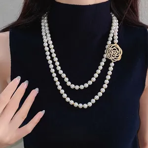 Elegant double-layered pearl necklace with hollow zircon rose pendant on model