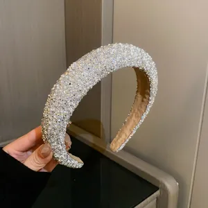 Close-up of luxury padded headband with shimmering rhinestones and elegant white pearls