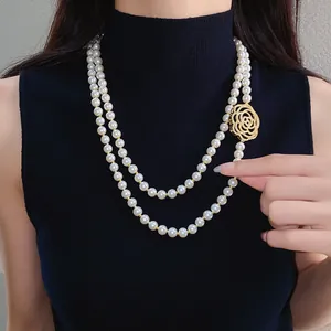 Detail of a double-strand pearl necklace with a hollow gold zircon flower clasp