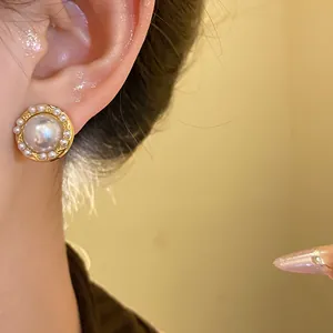 Detailed close-up of a French vintage pearl stud earring on a model, elegant aesthetic.
