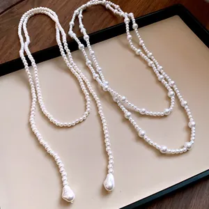 Detail view of French vintage long pearl necklaces with baroque drop pendants