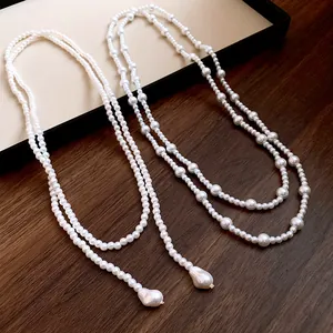 High-quality detail view of two French vintage style long pearl sweater chains.