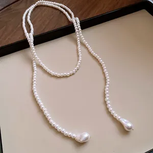 Elegant long pearl sweater necklace featuring teardrop-shaped baroque pearls on a tray.