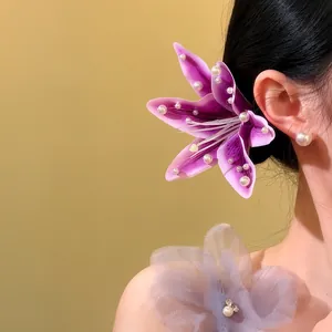 Elegant purple lily flower hair clip featuring white pearl accents for a sweet seaside style