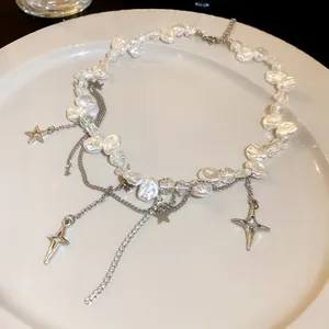 Detail view of a multi-layer pearl necklace with star pendants and rhinestones