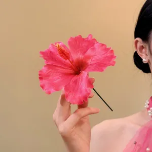 Elegant large pink fabric hibiscus flower hair clip perfect for a sweet seaside vacation look