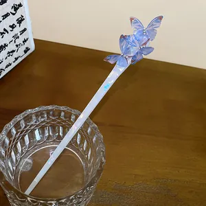 Detail of blue acetate butterflies and iridescent finish on an elegant hair stick