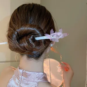 Close-up of an elegant butterfly acetate hair stick styled in a graceful hair bun.