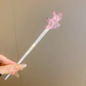 Detail shot of a sweet pink butterfly hair stick with pearlescent acetate finish.