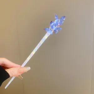 Detail view of a translucent acetate hair stick with blue butterfly charms