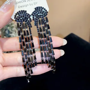 Close-up detail of luxurious black zircon long tassel drop earrings with crystal finish