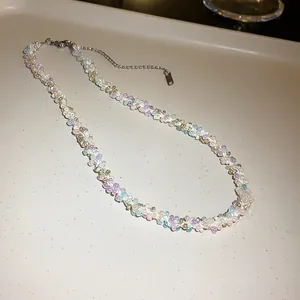 Close-up detail of a colorful hand-woven beaded necklace featuring soft pastel tones