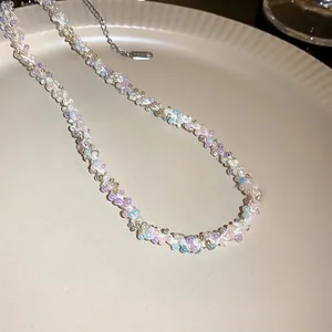 Detail view of a sweet colorful hand-woven seed bead necklace on a beige plate