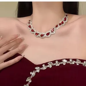 Close-up of luxury palace style necklace with teardrop red stones and sparkling rhinestones