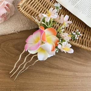Handmade floral hair comb featuring colorful fabric plumeria and white blossom detail