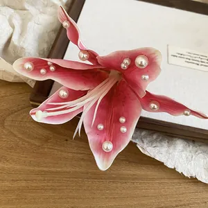 Pince à cheveux fleur de lys rose en tissu ornée de perles blanches pour femme