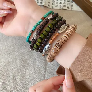 Close-up of Bohemian multi-layer bracelet set with wood, coconut, and turquoise beads