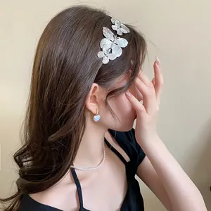 Elegant French style silver metal butterfly headband shown on a model for hair styling