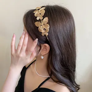 Detailed view of elegant French style gold butterfly headband on model side profile