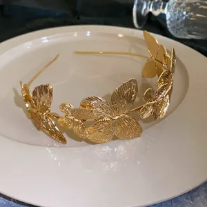 Macro view of detailed golden butterfly ornaments on vintage metal headband