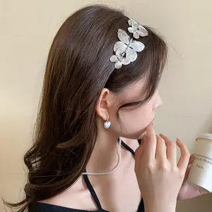 Macro view of an elegant retro silver metallic butterfly headband worn by a woman.