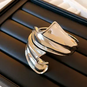 Detailed close-up view of the twisted irregular punk metal open cuff bracelet in silver finish