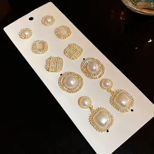 French retro earring set with faux pearls and sparkling rhinestones on display card.