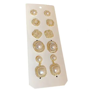 Elegant 5-pair set of French vintage pearl and rhinestone stud earrings in gold.