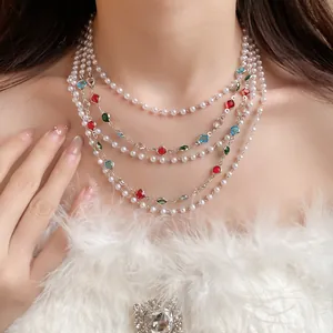 Close-up of elegant French vintage multi-layer pearl necklace with colorful stones