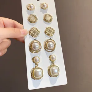 French vintage pearl and rhinestone earring set displayed on a white card