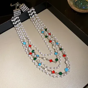 Detail view of a French vintage multi-layer pearl necklace with colorful gemstones.