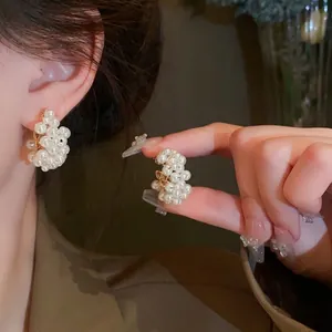 Elegant gold-tone cluster pearl earrings with silver needles and stylish design for women