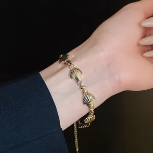 Elegant macro detail of a vintage gold shell link bracelet with striped texture on wrist