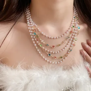 Close-up of a French vintage multi-layered necklace with pearls and colorful gemstones.