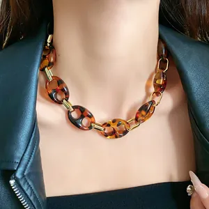 Detailed view of retro tortoise shell link necklace with elegant gold-toned metal accents