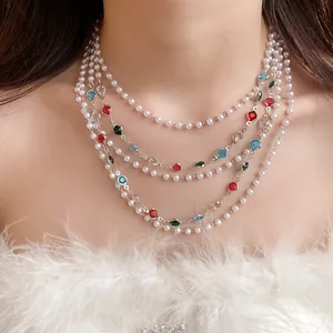 Close-up detail of a French retro multi-layer pearl necklace with vibrant gemstone accents