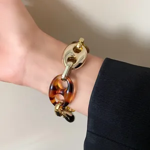 Detail view of chunky retro gold and tortoiseshell chain link bracelet for women