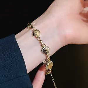 Close-up of vintage gold shell striped bracelet on a wrist showing intricate details