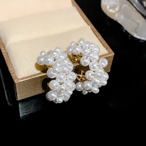 Detailed view of elegant hollow heart pearl cluster earrings with s925 silver needle studs