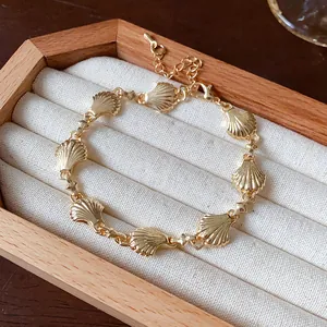 Detailed view of a vintage gold-tone shell link bracelet resting in a jewelry display box