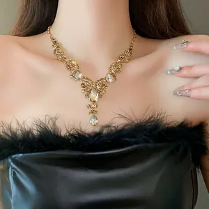 Elegant vintage necklace with gold-toned rhinestone drop pendants on a model's neck