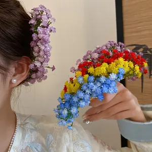 Close-up of colorful baby's breath flower hairpins worn in hair for a sweet look